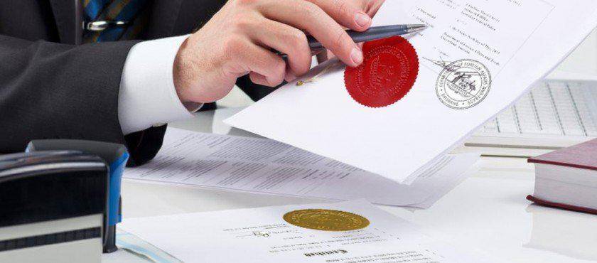 Professional handling official documents with embossed red and gold seals for apostille certification