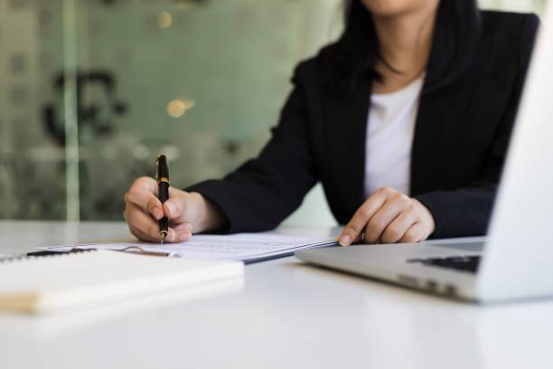 About Us-Legal document assistant reviewing paperwork and assisting a client at TrustPoint Disability & Legal Services in San Jose.