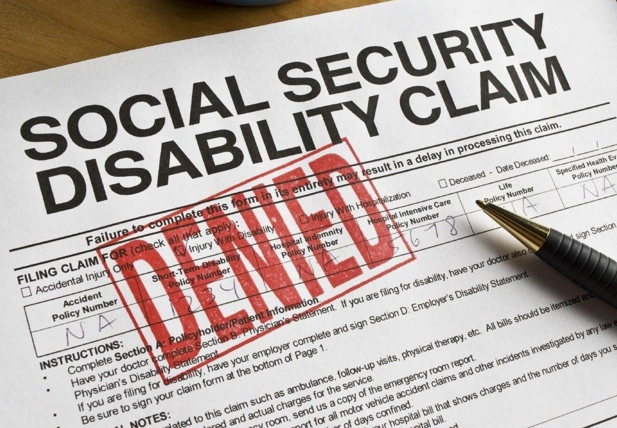 A denied Social Security Disability claim form with a bold red “DENIED” stamp, symbolizing the need for local disability help and appeal services.