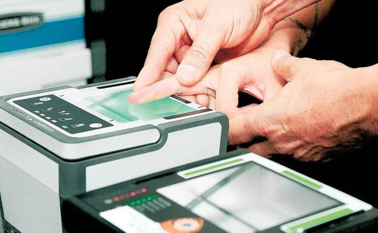 Live scan fingerprinting being performed on a digital fingerprint scanner for background check or legal requirement.
