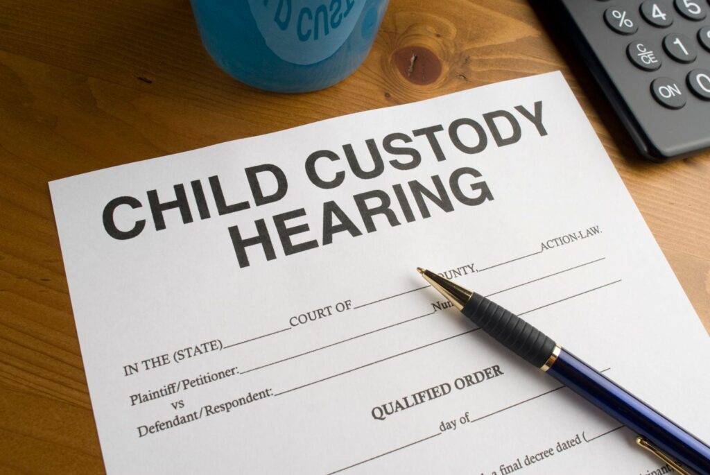 Child custody hearing document with pen on desk representing family law and divorce help services.