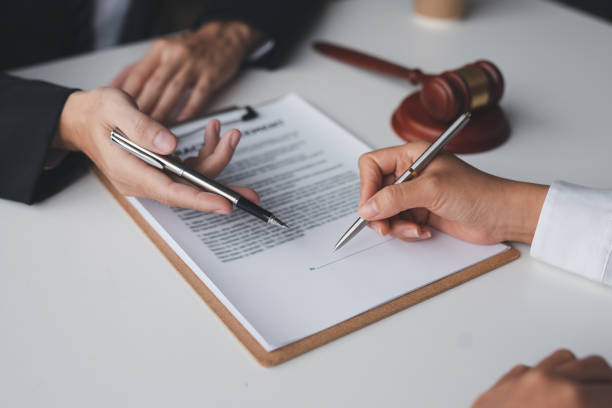 Client signing real estate legal contract with assistance from TrustPoint Disability & Legal Services LLC