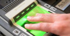 About Fingerscan Digital capturing a customer’s fingerprints using a live scan machine for background check and identification purposes.