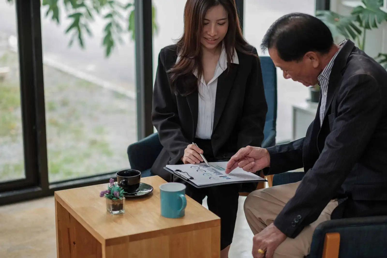 Quinnie Do, Registered Legal Document Assistant LDA #268, explaining California court petition documents to a client at the TrustPoint San Jose office